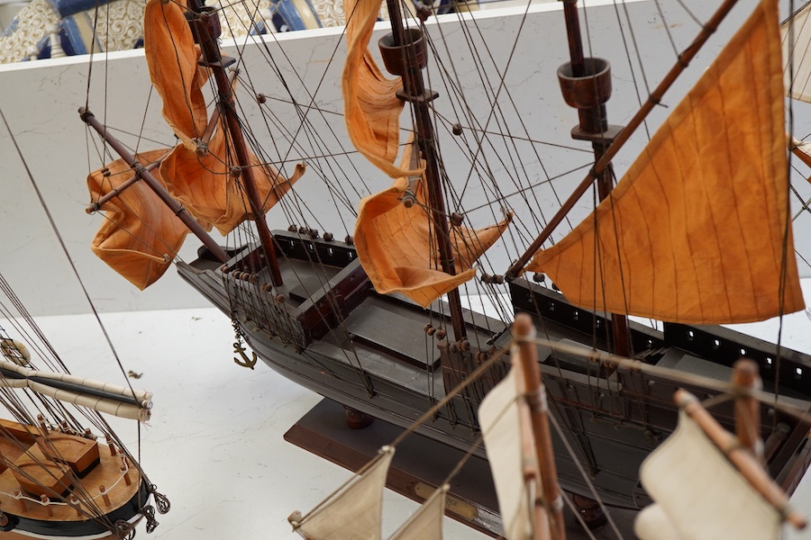 A collection of ten wooden models of famous ships including; the Cutty Sark, HMS Victory, the Mayflower, Revenge, and Santa Maria, largest 125cm wide